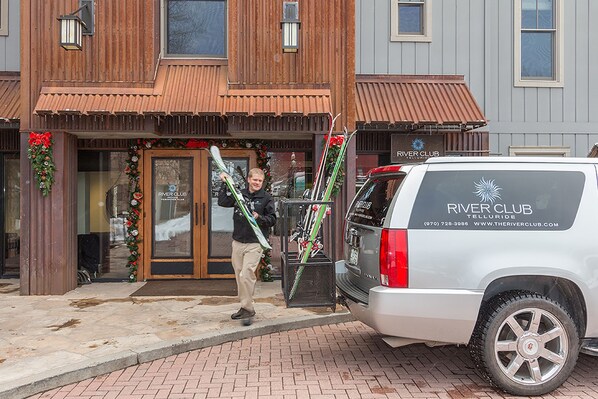 A building with a wooden facade and a sign that reads 'River Club Telluride.'