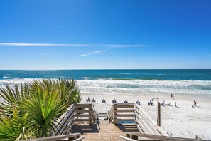 A wooden boardwalk leading to a beach with lounge chairs and people. - Mistral 8☀--Gulf Front, Beautiful Views with Private Beach (Seacrest Beach)