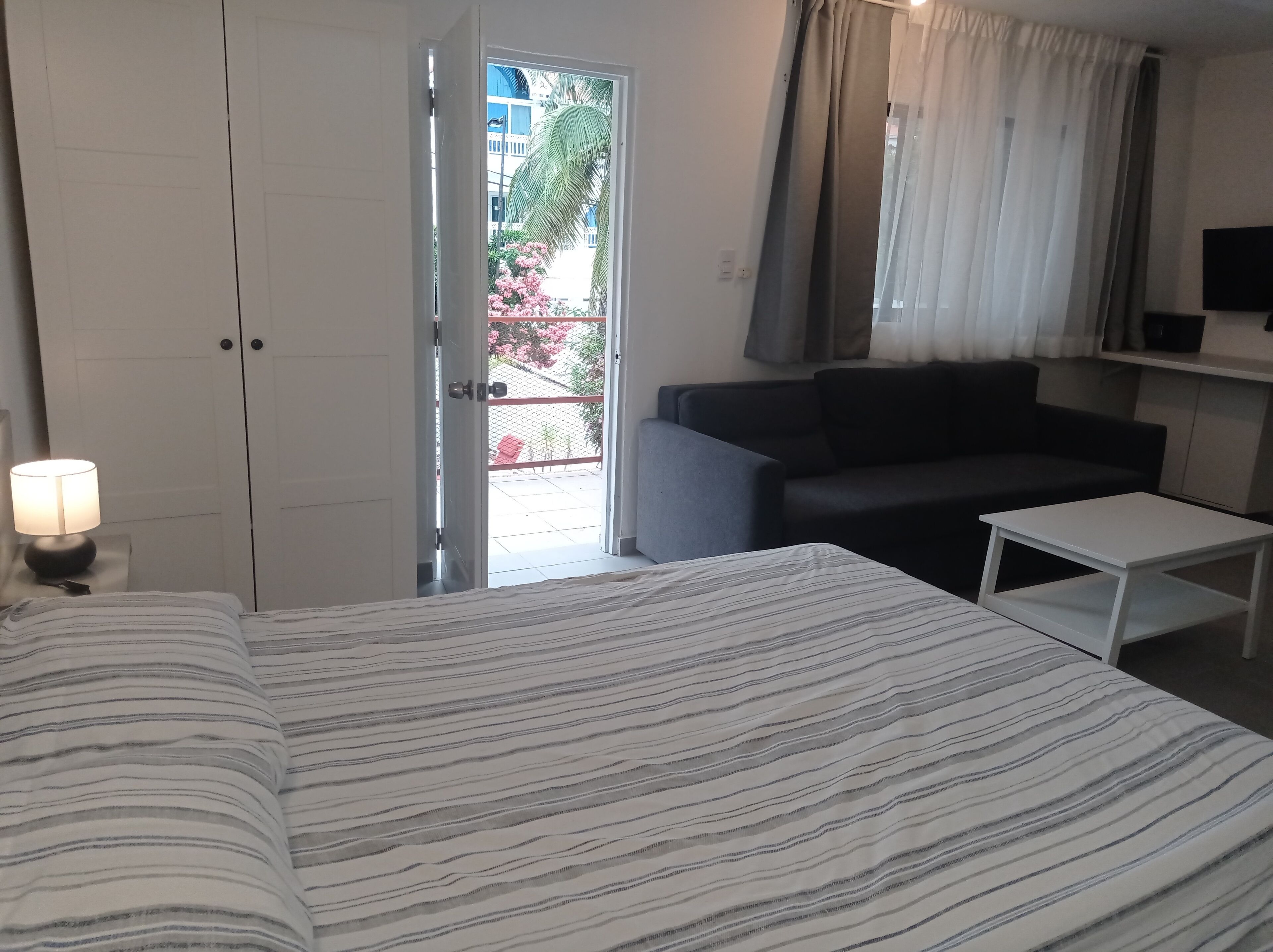 classic double room, multiple beds, balcony, pool view | in-room safe, desk, laptop workspace, blackout curtains