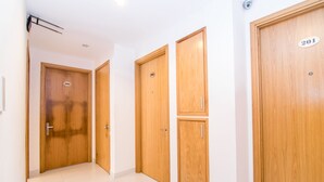 A corridor with wooden doors numbered 201, 202, and 203. - RedDoorz Plus near SECC D7 (Ho Chi Minh City)