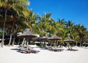 On the beach, sun loungers, beach umbrellas, beach towels