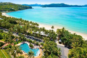 A resort with a pool, beach, and palm trees. - Hamilton Island Vacation Rentals (Whitsundays)