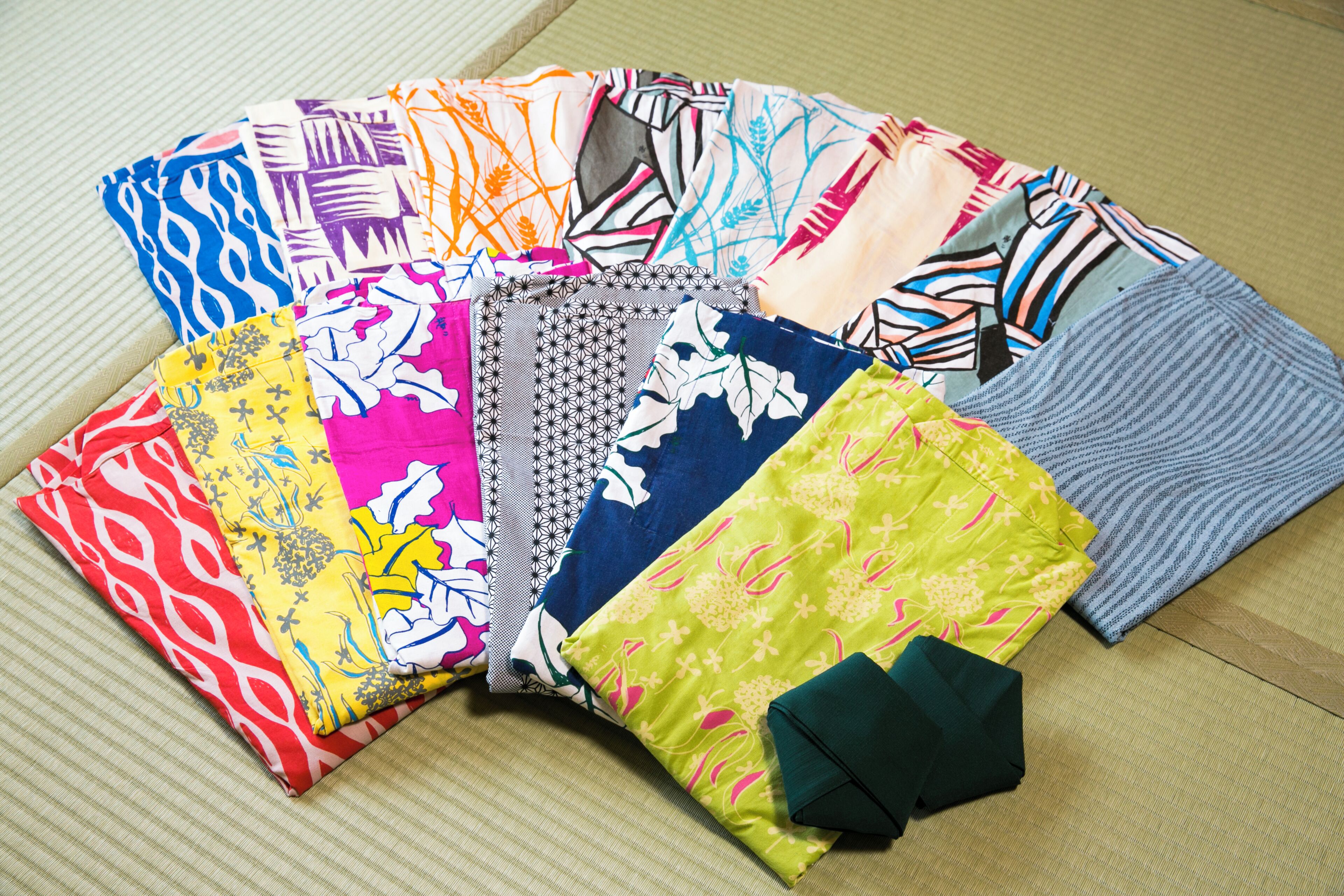 A variety of colorful fabrics laid out on a surface.