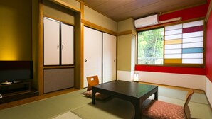 A traditional Japanese room with tatami flooring, a low table, and sliding doors. - Yumoto Komachikan (Yugawara)