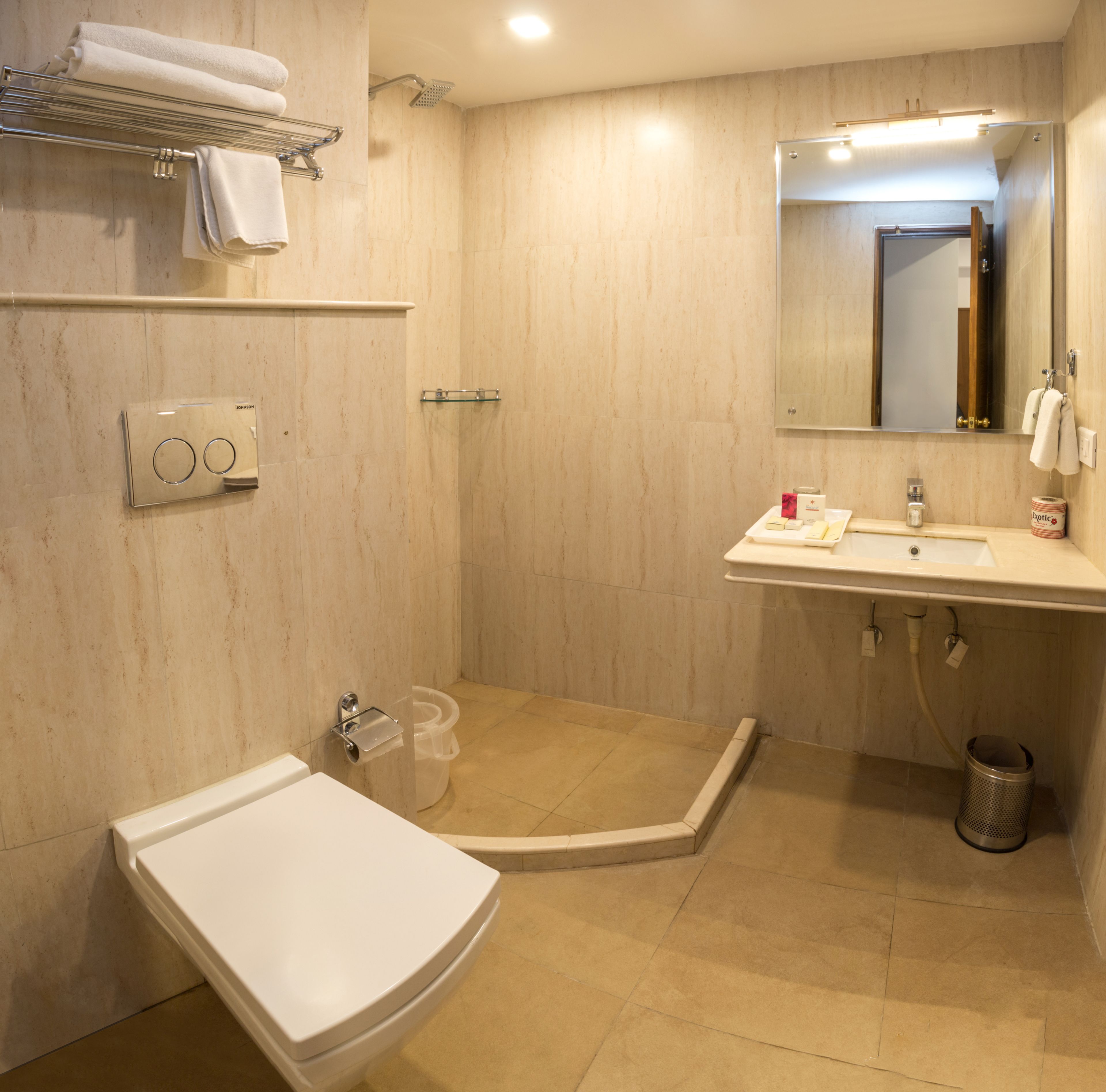 A bathroom with a shower, toilet, and sink.