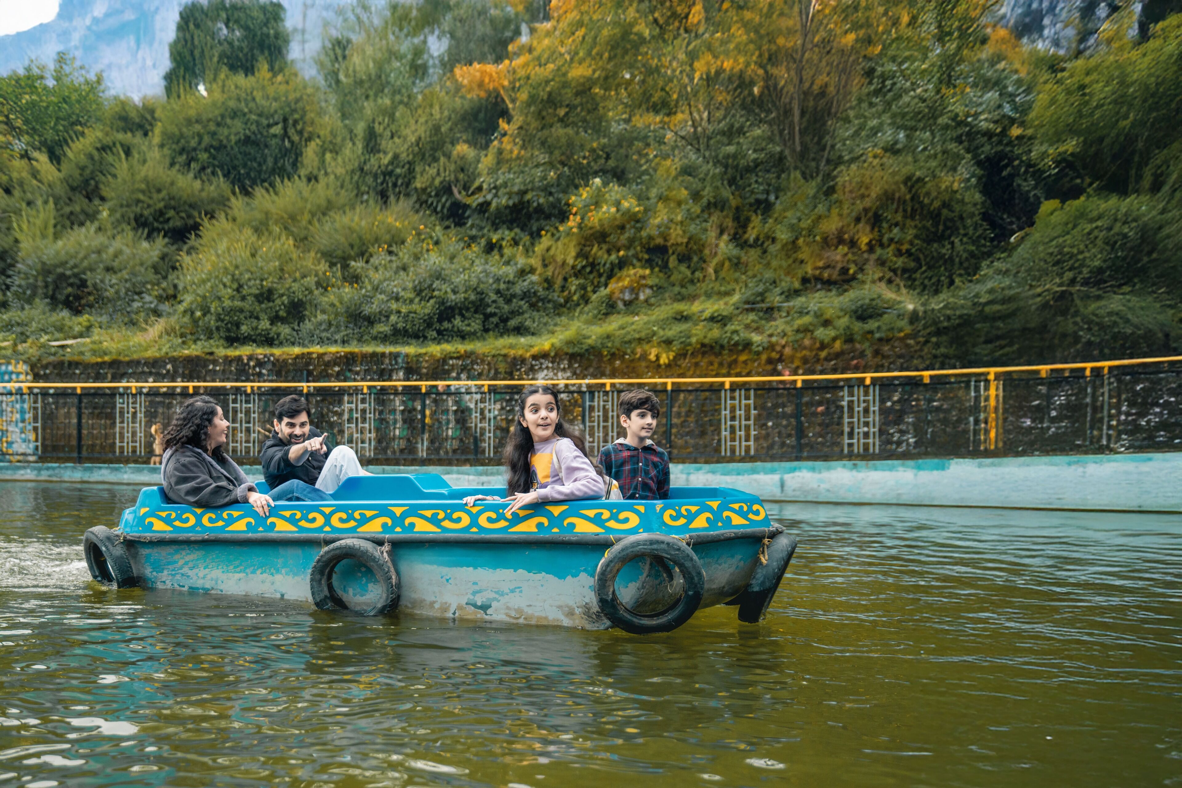 A boat with passengers, surrounded by water and greenery.