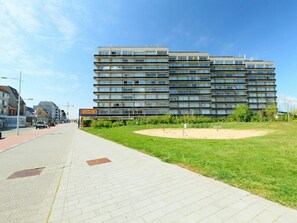 A multi-story building with a modern architectural design, featuring a flat roof and a uniform facade.