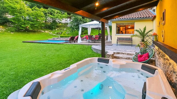 A hot tub in a backyard with a patio, a covered seating area, and a swimming pool. - Wonderful private villa with WIFI, private pool, hot tub, A/C, TV, patio and pets allowed (Rijeka)