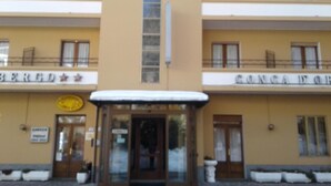 A hotel facade with a central entrance, balconies, and signage. - Hotel Conca D'Oro (Lama Mocogno)