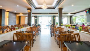 A spacious restaurant with high ceilings, modern lighting, and a central open area. - Sansuk Apartment (Pathum Thani)