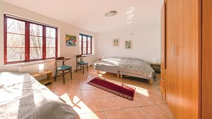 A bedroom with two beds, a desk, chairs, and a radiator. - 3 bedroom cozy home in Tomelilla (Tomelilla)