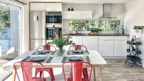 Una cuina moderna amb armaris blancs, forn Bosch i nevera Siemens.