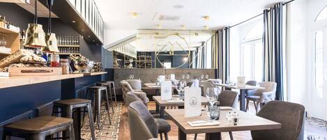 A restaurant with a bar area, seating, and a patterned floor.