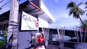 A building with a sign reading "Chill Inn Beach Cafe Hostel". - Chill Inn Beach Cafe & Hostel (Koh Samui)