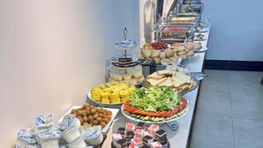 A buffet with various food items including fruits, vegetables, and desserts. - Green Hadong Hotel (Hanoi)