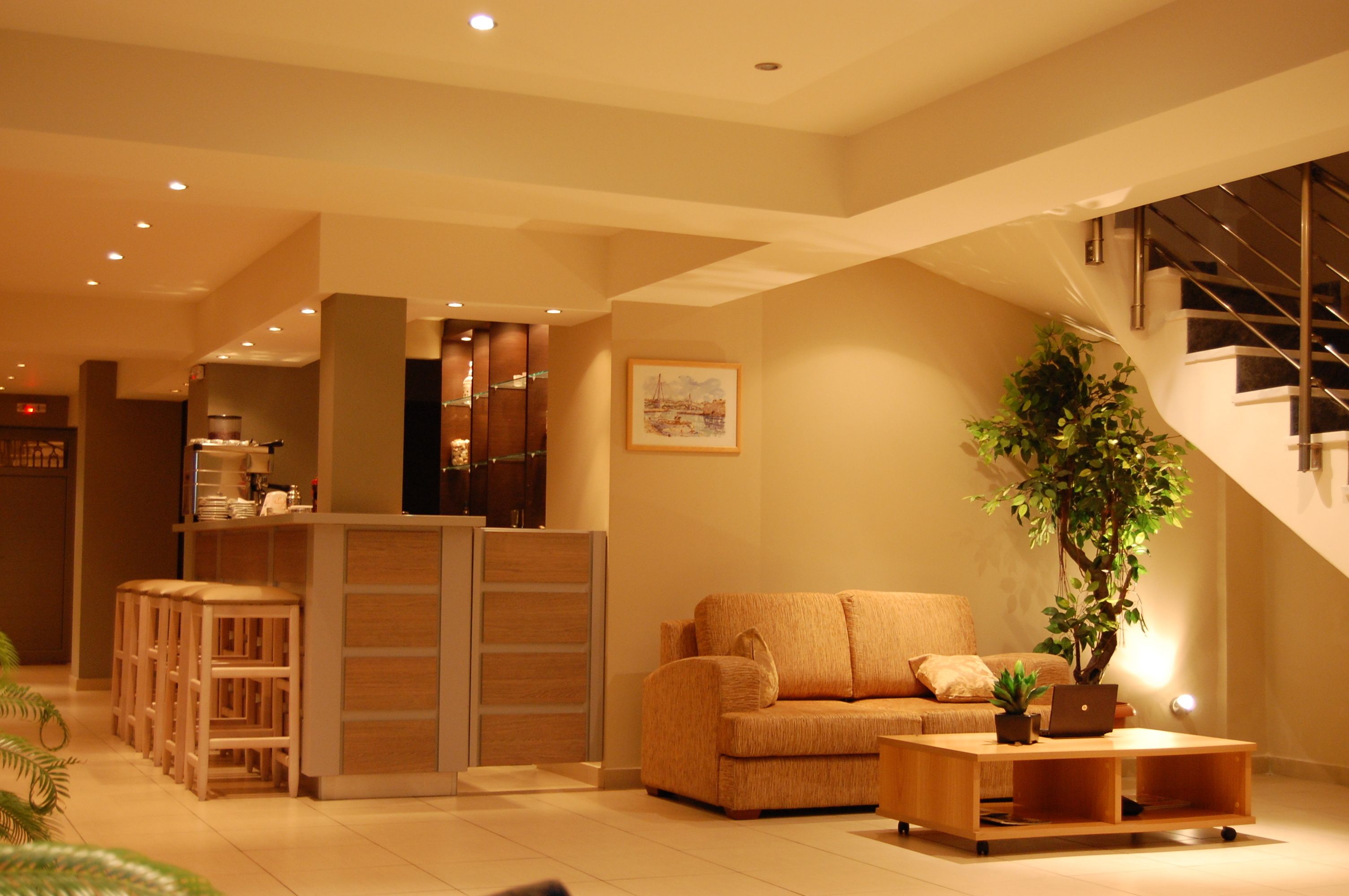 A modern living room with a sofa, coffee table, and a staircase.