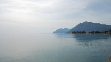 A calm lake with mountains in the background.