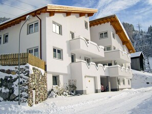 Stunning multi-story building with a white exterior and balconies.
