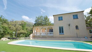 A two-story building with a swimming pool, surrounded by greenery and hills. - Awesome home in Ville di Paraso with WiFi (Ville di Paraso)