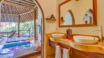 Bathroom features a large oval-shaped sink, matching vanity, and a wooden vanity with a mirror above.