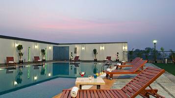 Outdoor pool, open 6 AM to 6:30 PM, pool umbrellas