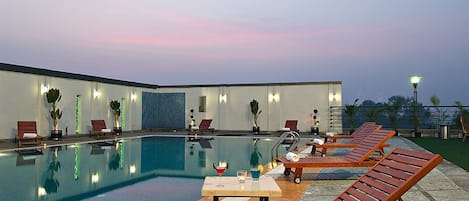 Outdoor pool, open 6 AM to 6:30 PM, pool umbrellas
