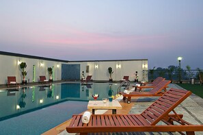 Outdoor pool, open 6 AM to 6:30 PM, pool umbrellas - Mind Space Hotel, Pimpri (Pune)