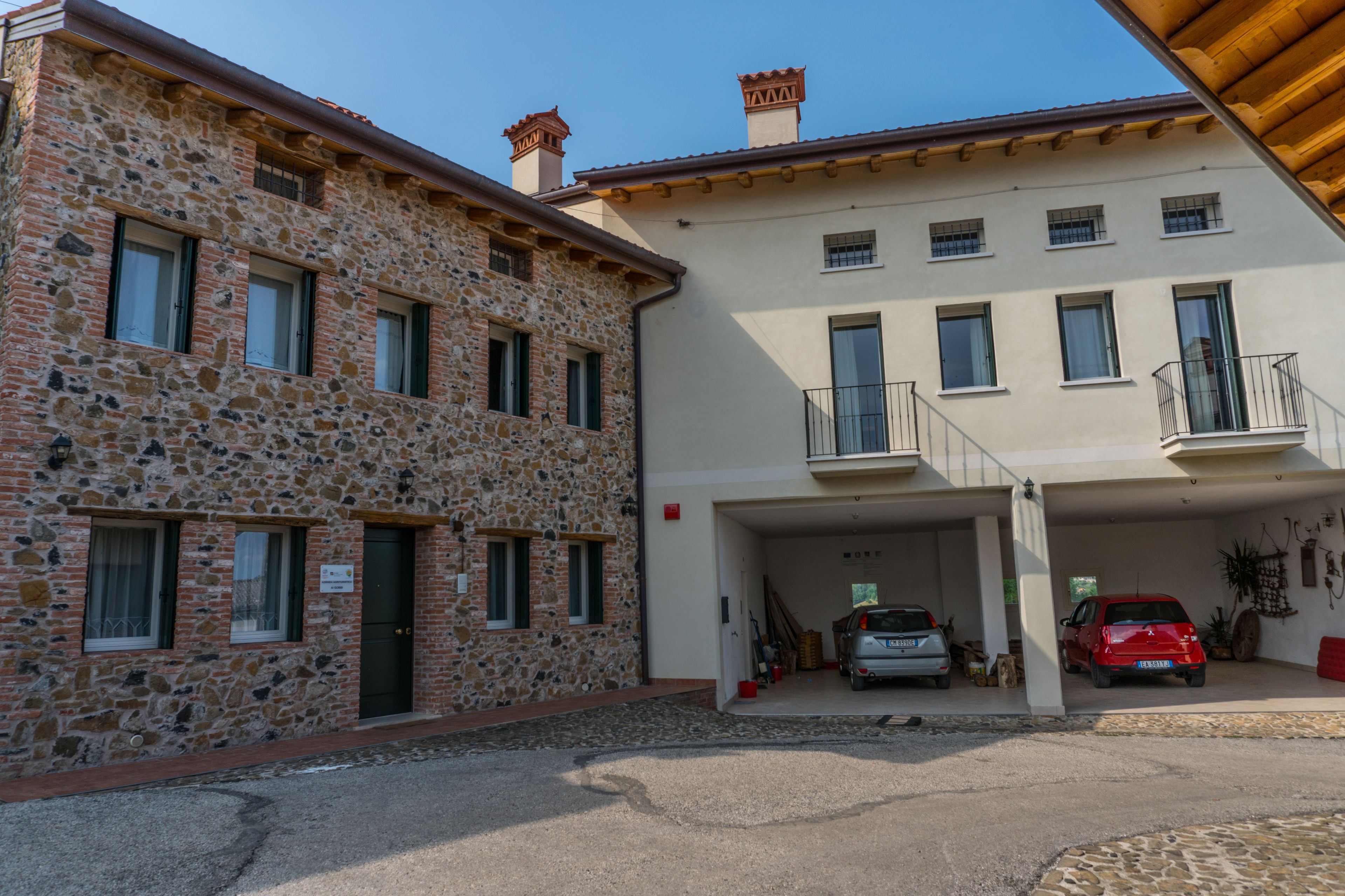 A two-story building with a stone facade and a flat roof.