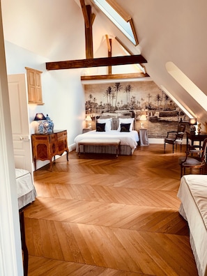 A spacious bedroom with a large bed, wooden floor, and a mural of a tropical landscape. - Château d'Auteuil (Berneuil-en-Bray)