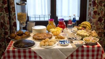 A buffet table with various food items and condiments.