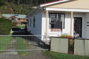 A single-story house named "Arthurstow River View House" with a front porch and a gated entrance.