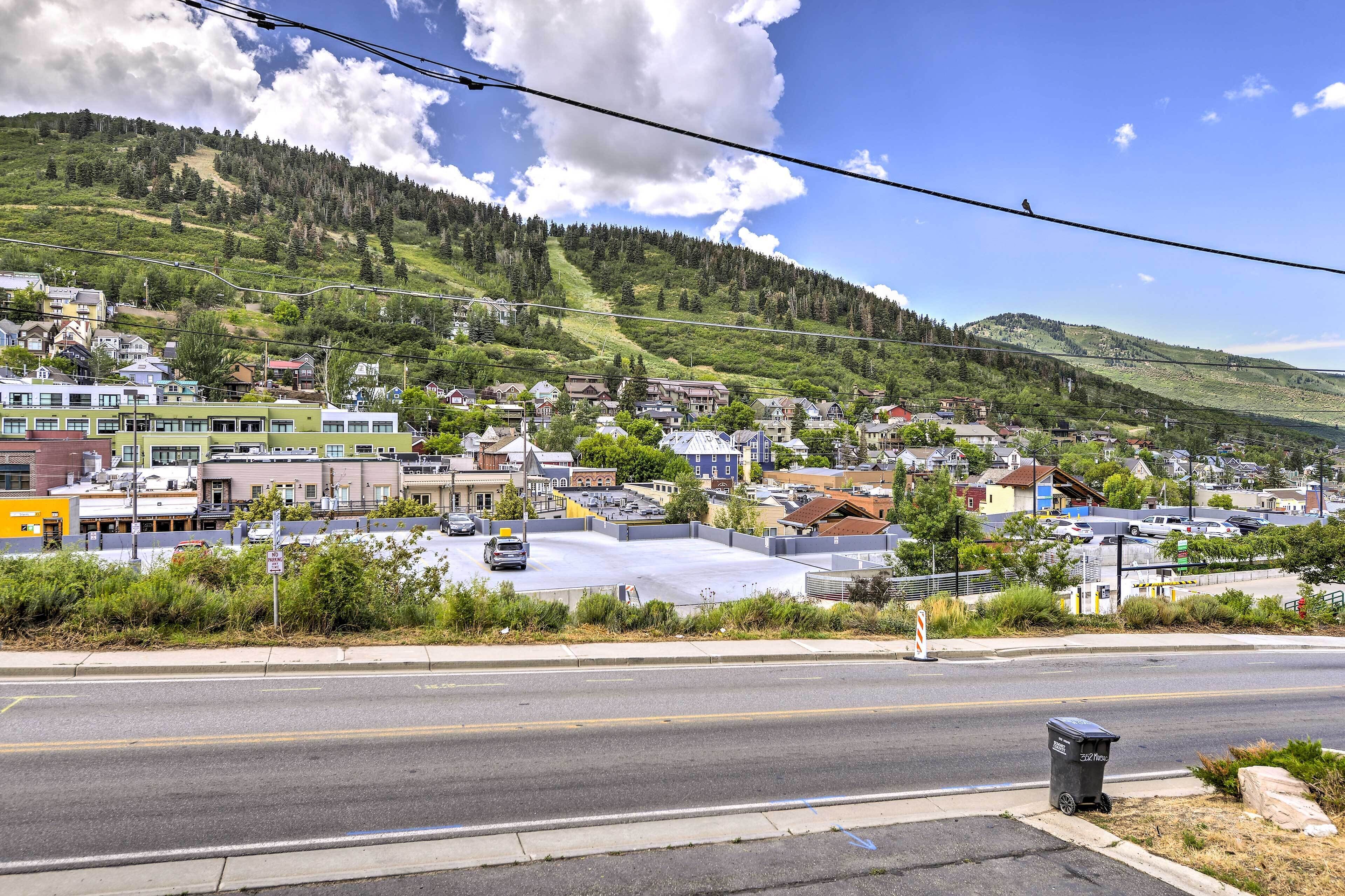 A town with buildings, a road, and a mountain in the background.