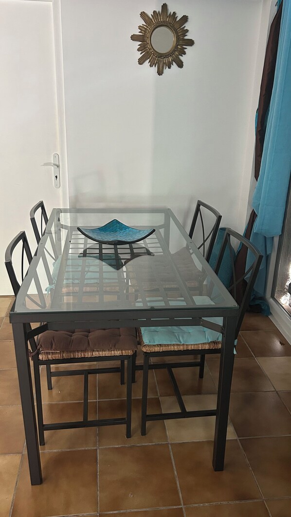 A dining table with chairs, a decorative mirror, and a blue curtain. - House / Villa - LE TIGNET (Le Tignet)