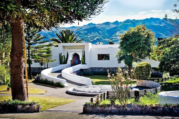 North side, main entrance with private gardens and volcanoe Mojanda in the back