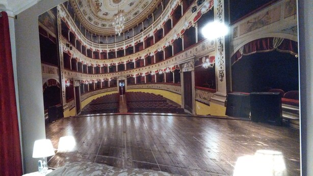A theater with a central stage, multiple balconies, and ornate ceiling decorations. - B&B Salita Metello (Agrigento)