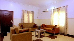 A living room with two sofas, a coffee table, and a door.