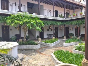 Stroll through this serene courtyard, surrounded by lush greenery and tranquil atmosphere.