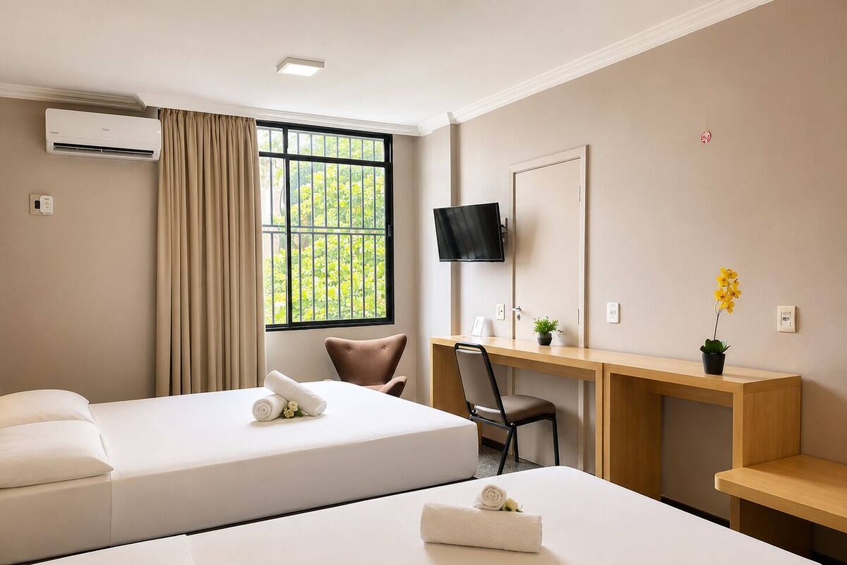 Deluxe Triple Room | Minibar, in-room safe, desk, laptop workspace