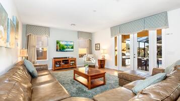 Family House | Living room | 55-inch TV with satellite channels, video-game console, foosball