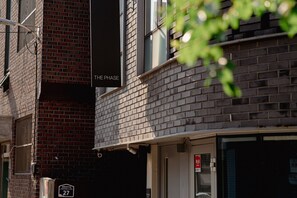 A brick building with a black awning and a sign that reads "THE PHASE". - The Phase Boutique Hotel (Seoul)