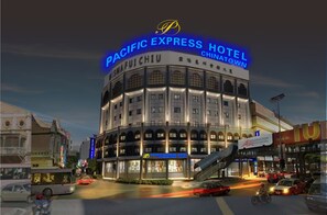 A hotel with a prominent sign reading "PACIFIC EXPRESS HOTEL CHINATOWN."