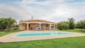 A house with a swimming pool, outdoor seating, and a garden. - Lovely home in Costa Rei -CA- (Costa Rei -CA-)