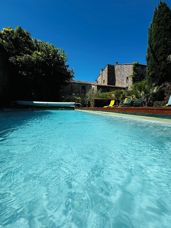 A heated pool, sun loungers