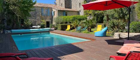 A heated pool, sun loungers