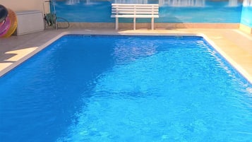 Outdoor pool, a heated pool, pool loungers