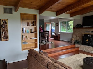 Relax in this inviting living area with a comfortable sofa, bookshelf, and fireplace.