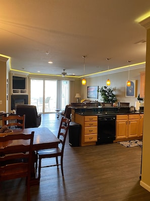 Enjoy meals in the spacious kitchen and dining area with a central island, large window, and ceiling fan.