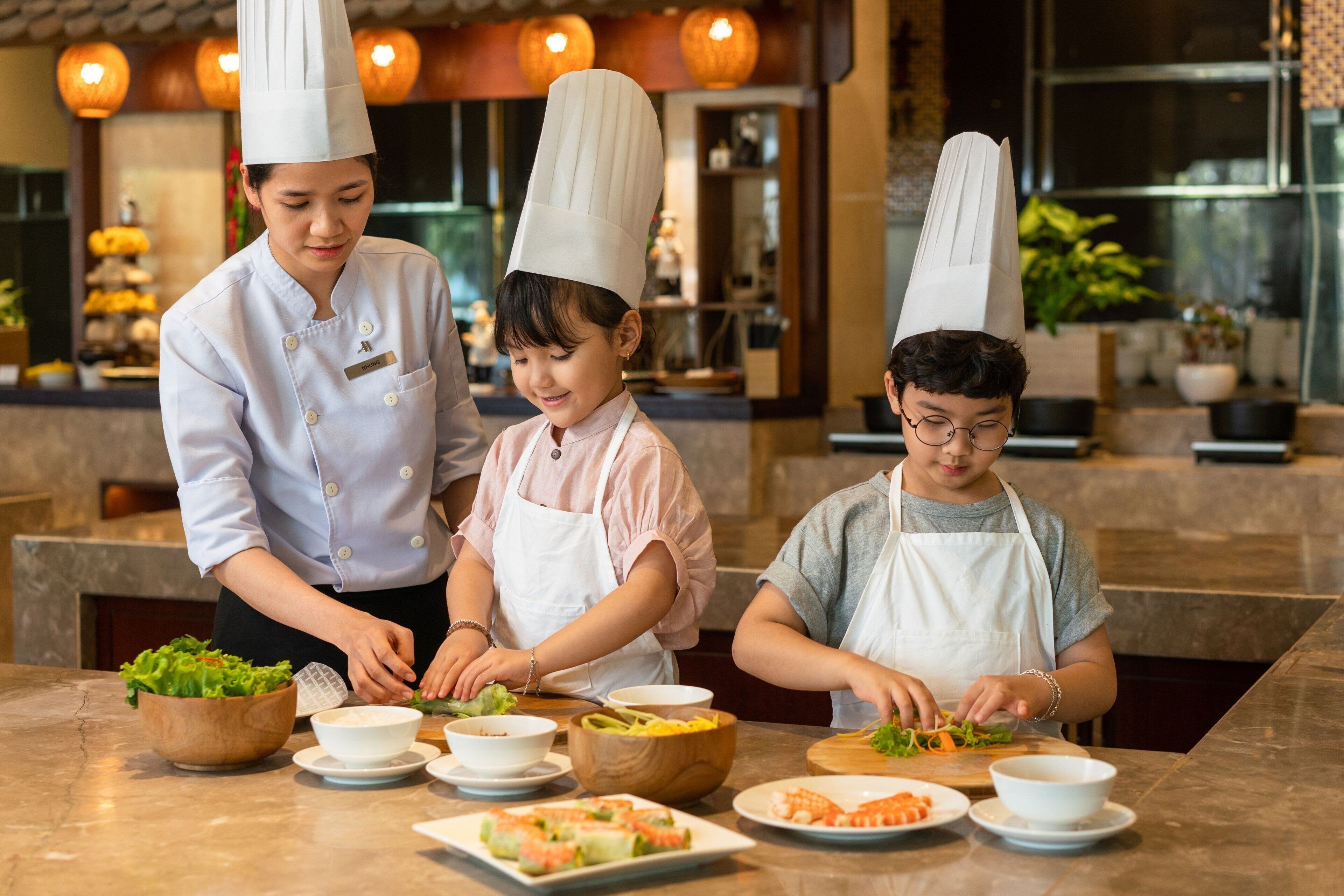 A group of people in a kitchen preparing food.