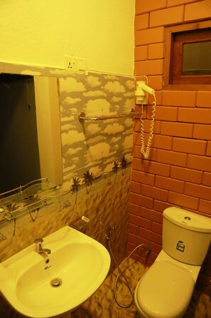 A bathroom with a marble sink, a toilet, and a telephone.