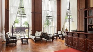 A spacious room with large windows, wooden furniture, and a cabinet. - Le Castle River Hotel & Apartment (Phnom Penh)